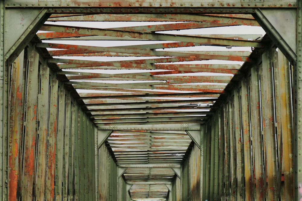 a long metal bridge with lots of rust on it