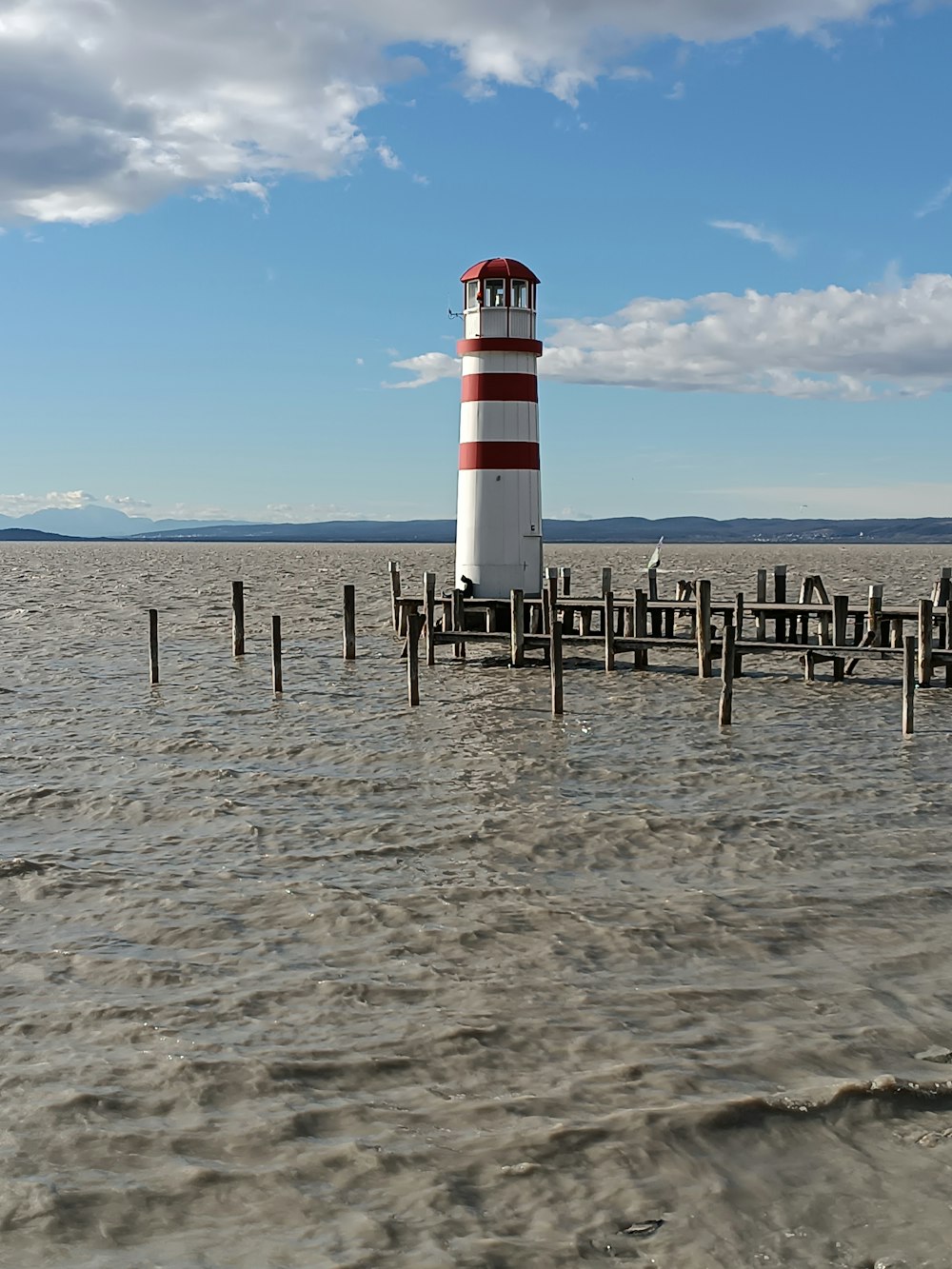 a light house in the middle of a body of water