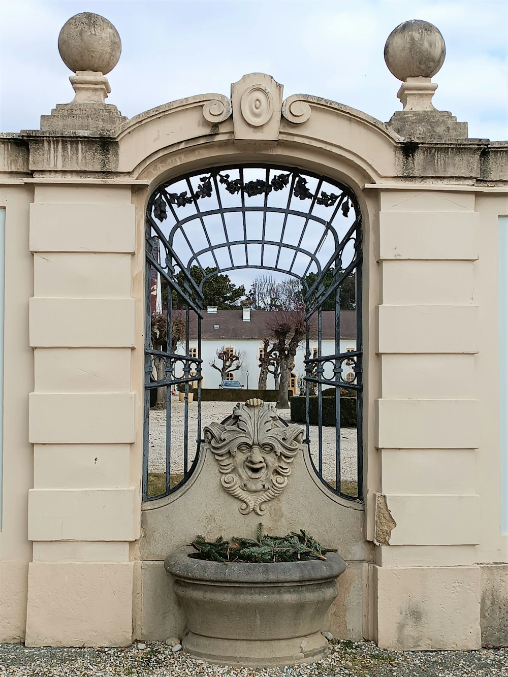 a gate with a fountain in front of it