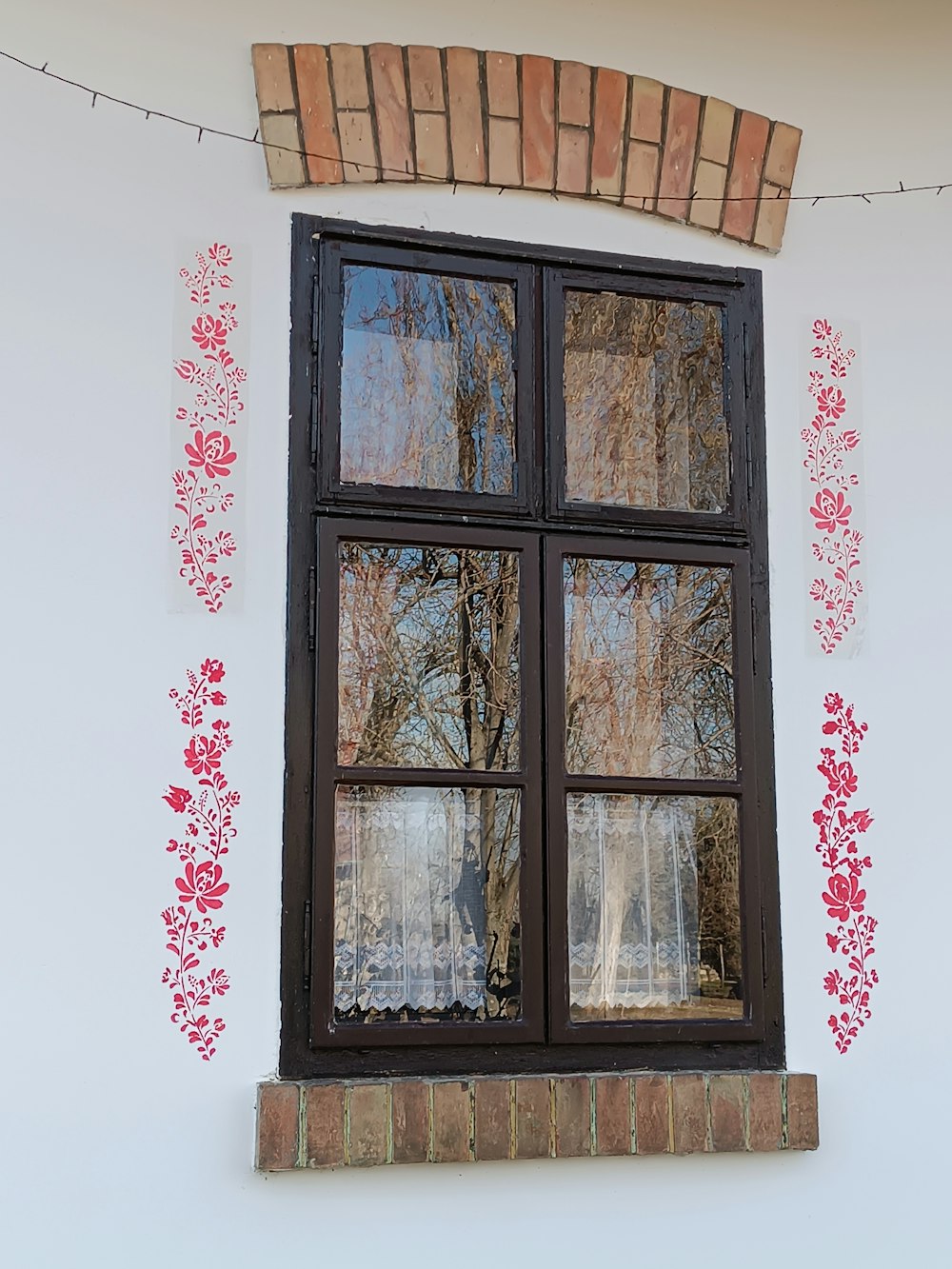 a window with a red flowered design on it