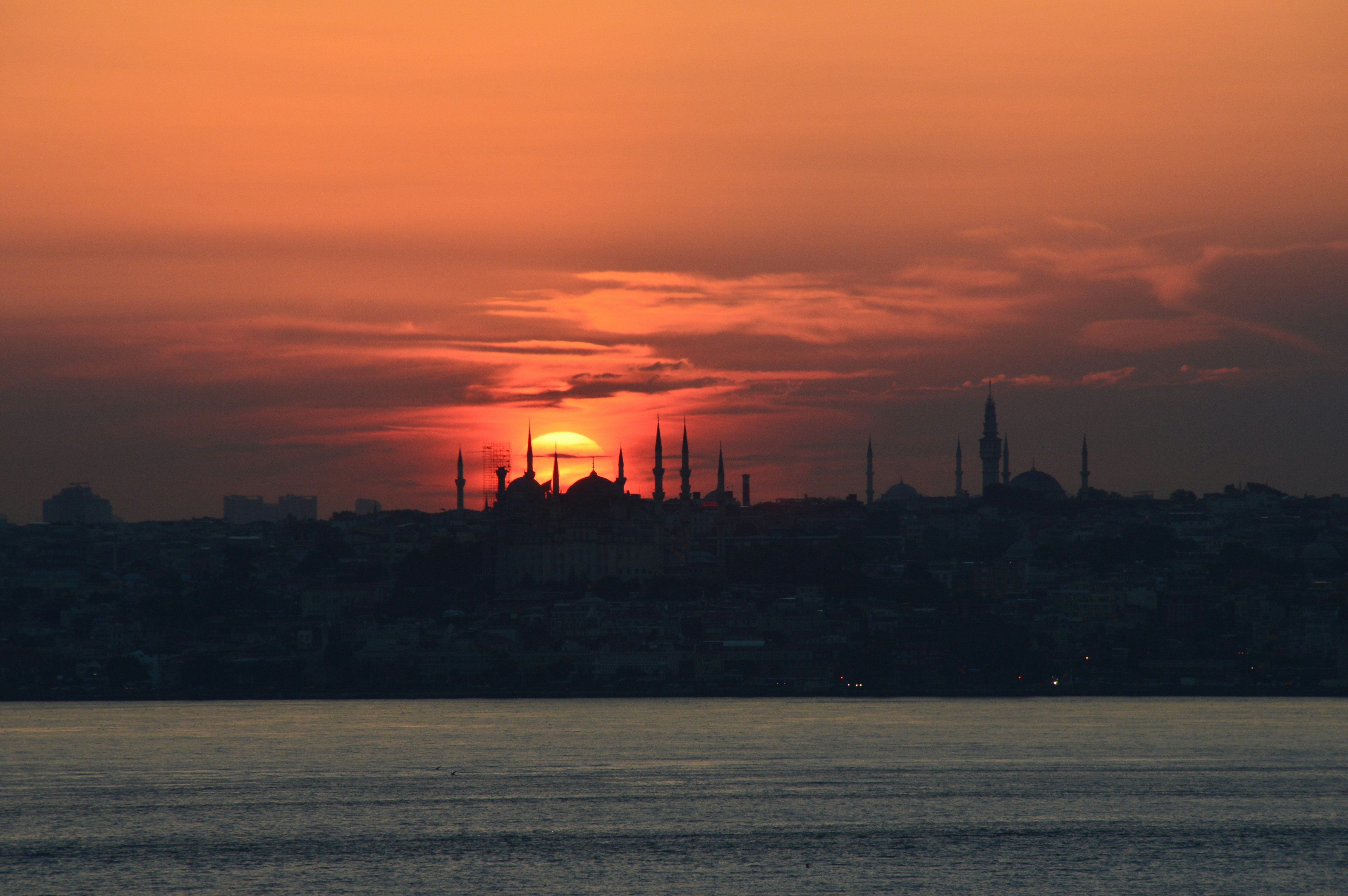 the sun is setting over a large city