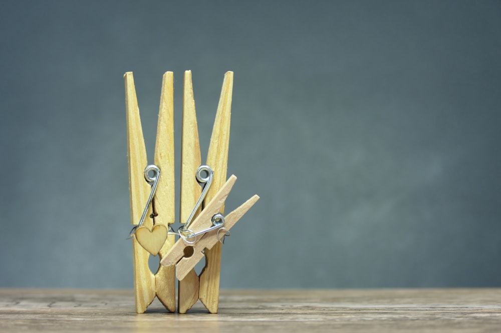 a pair of scissors are stuck in a piece of wood