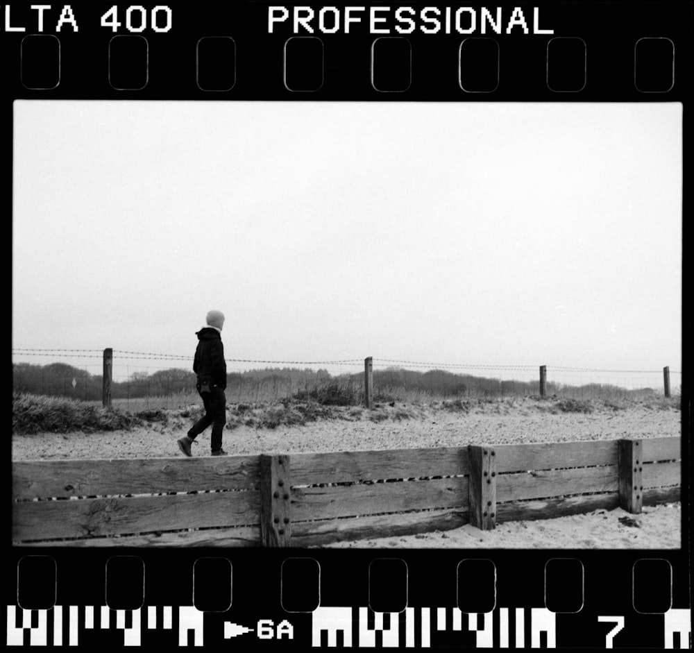 a black and white photo of a person walking