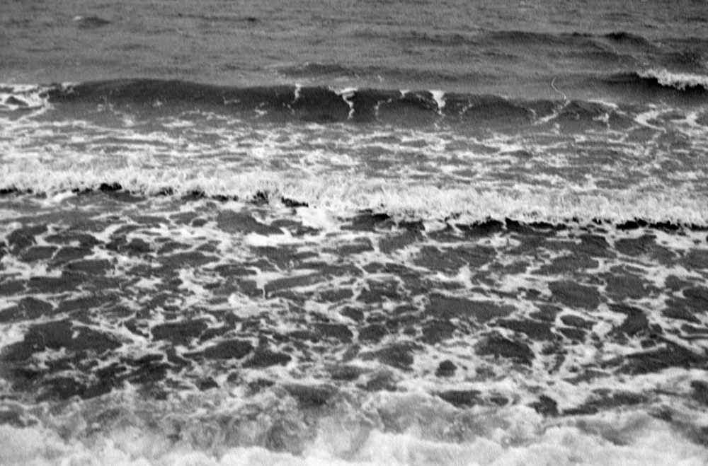 a man riding a surfboard on top of a wave in the ocean