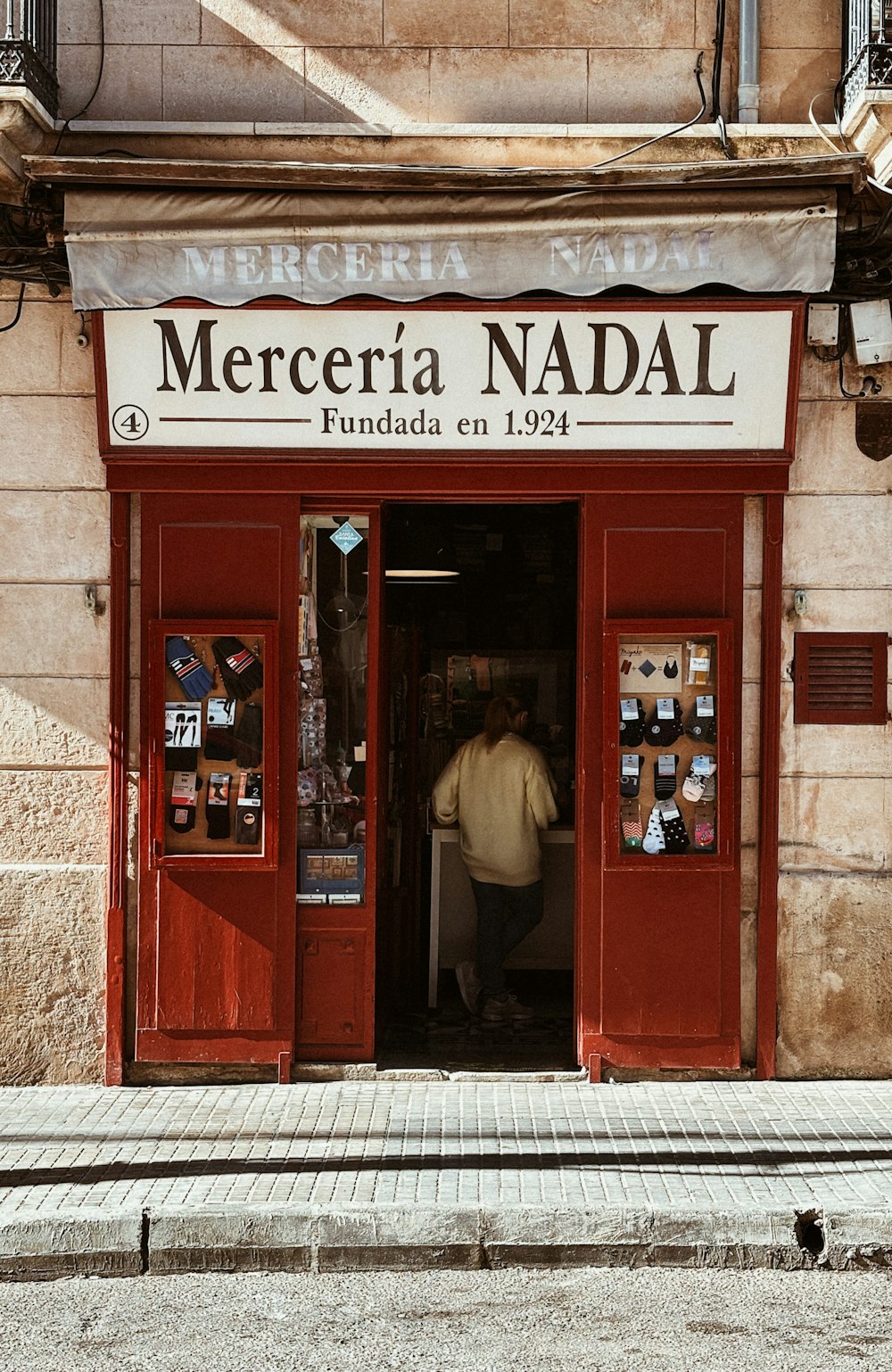 a man standing in the doorway of a store