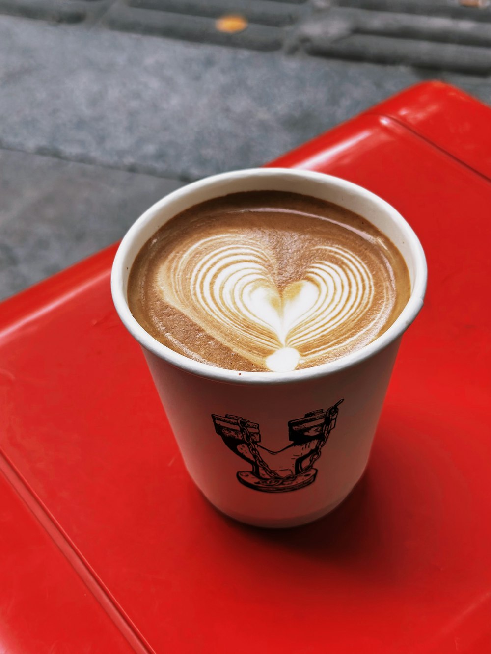 a cup of coffee on a red table