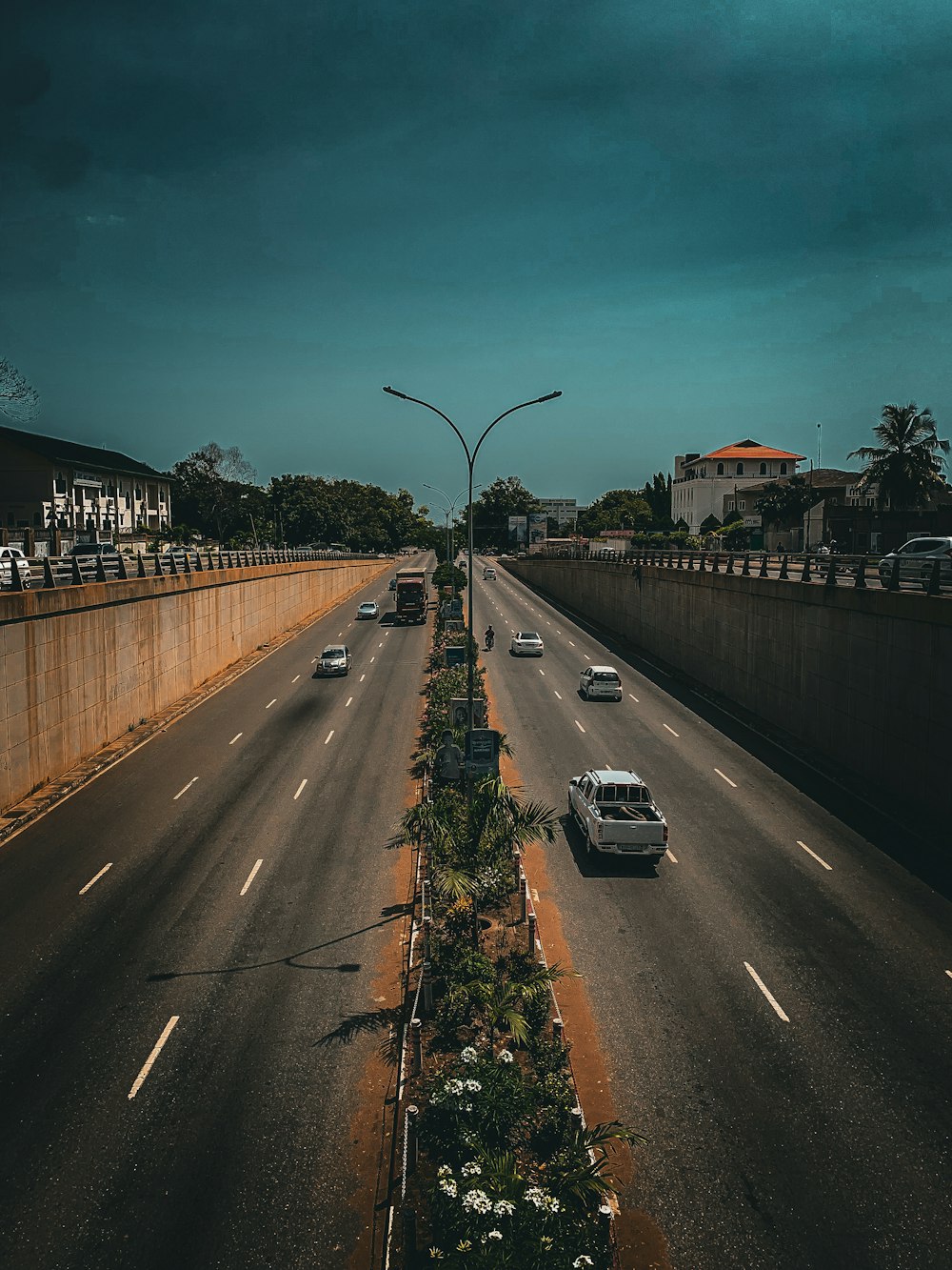 a highway with cars driving down it under a cloudy sky