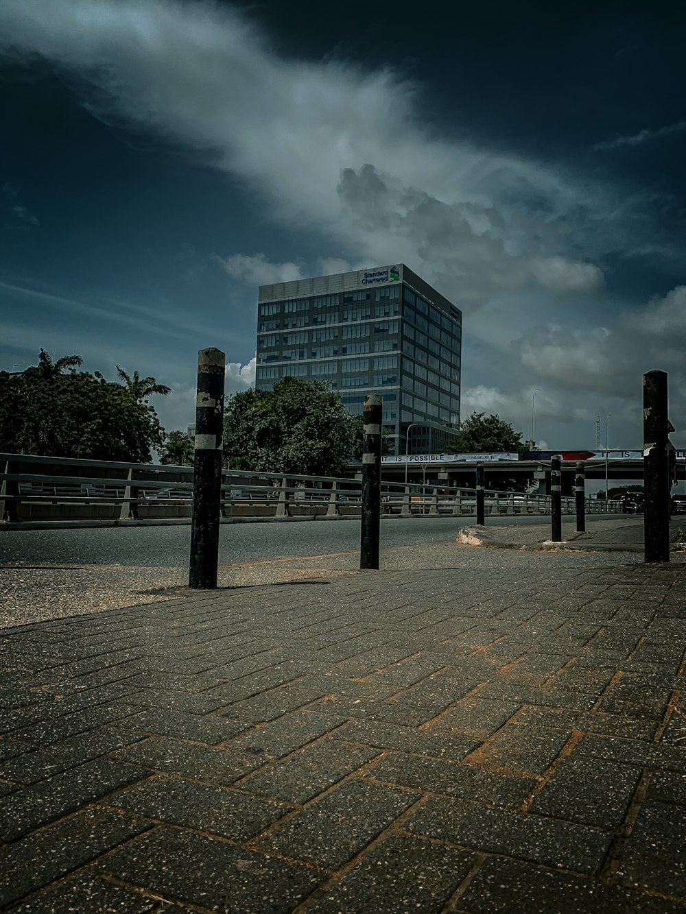 a city street with a tall building in the background