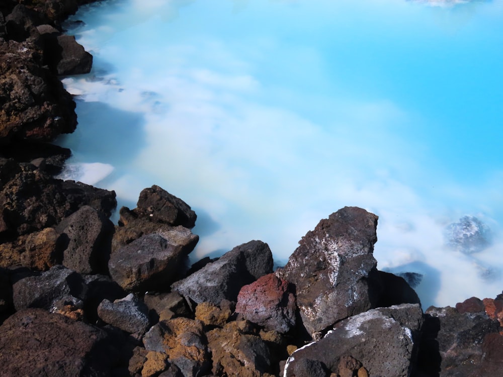 a blue pool of water surrounded by rocks