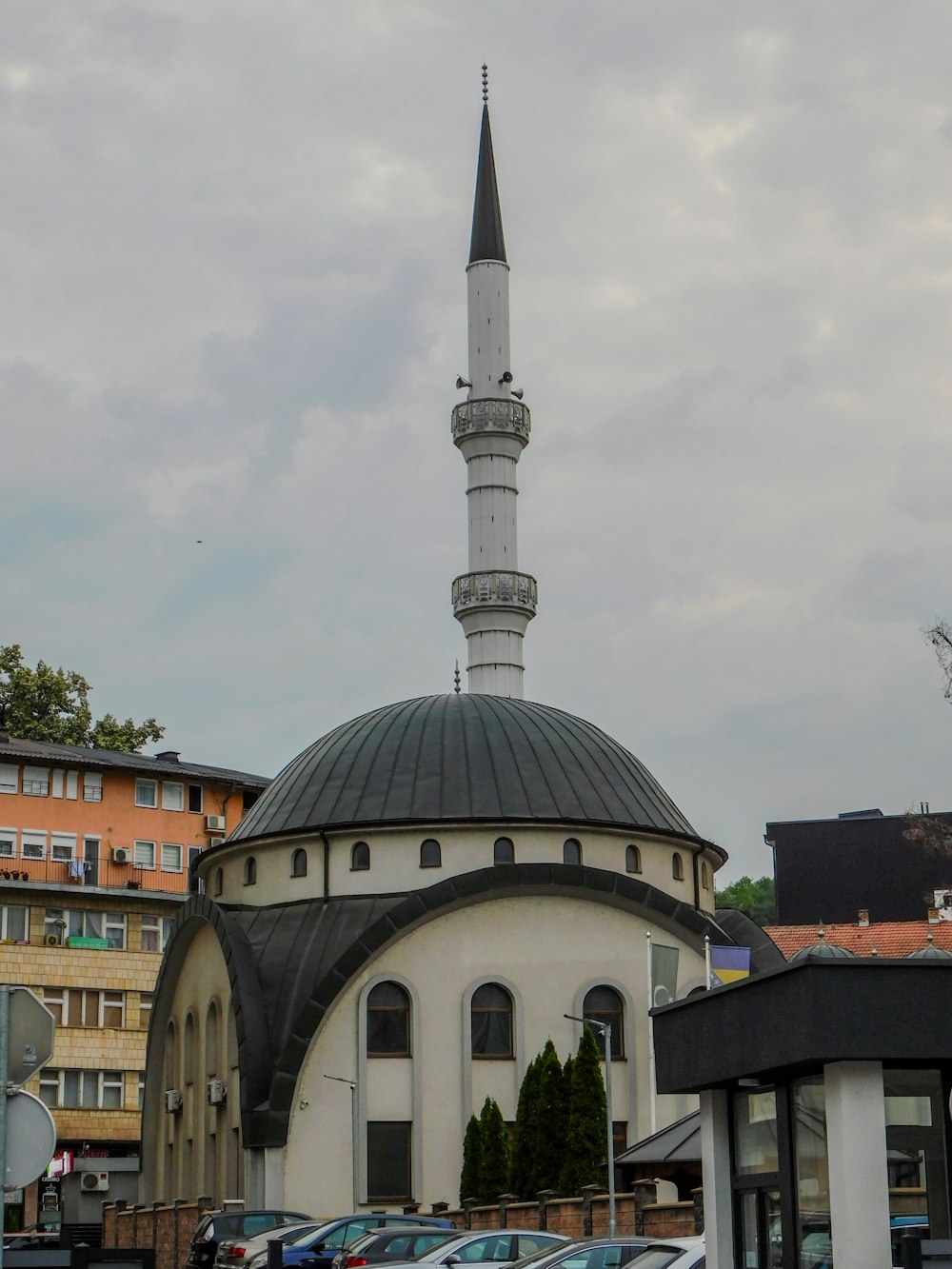 a large white building with a black roof