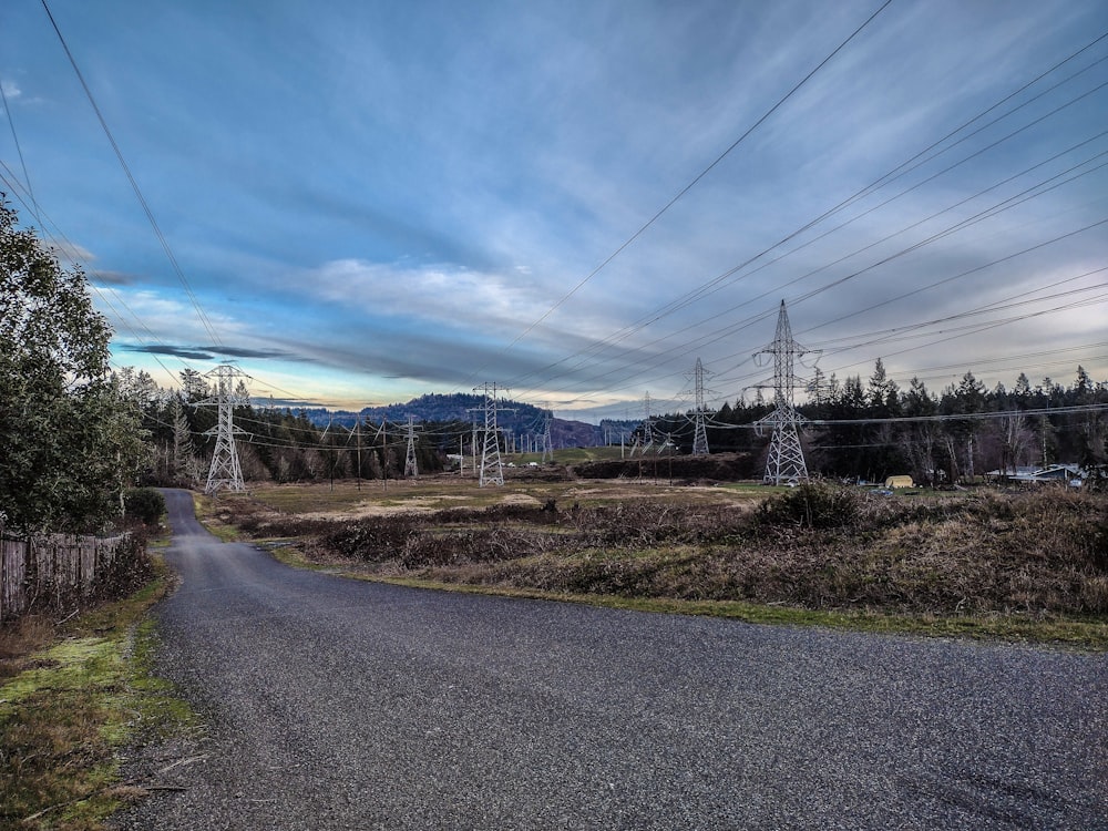 an empty road with power lines in the background