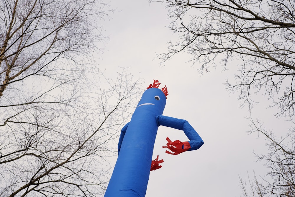 a blue pole with a face painted on it