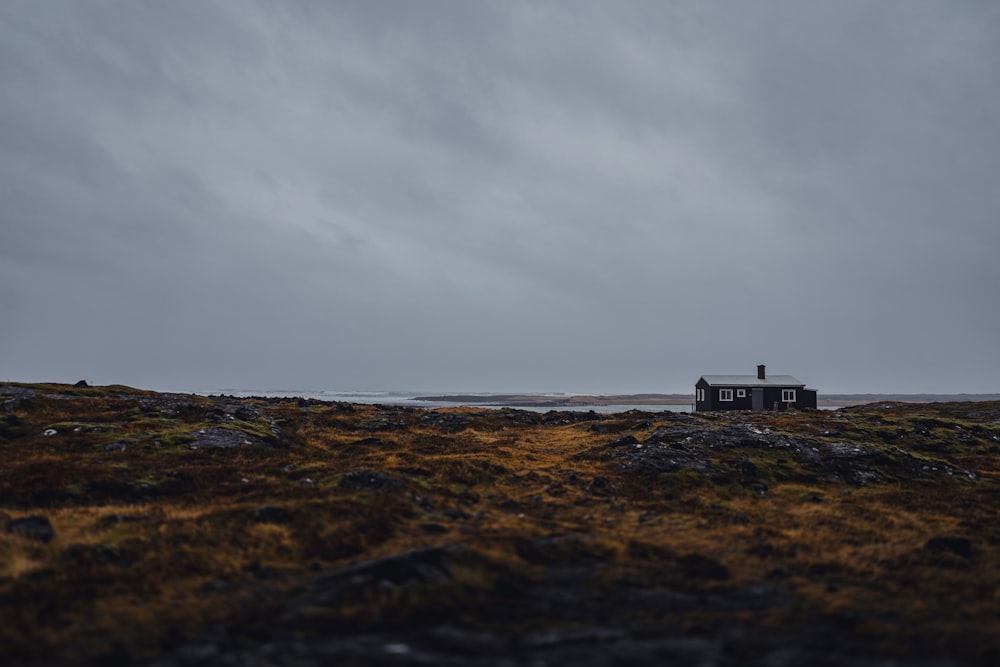 a small house sitting on top of a grass covered field