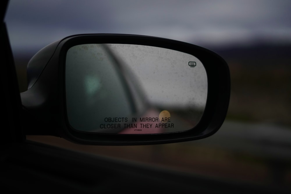a side view mirror with a picture of a car in it