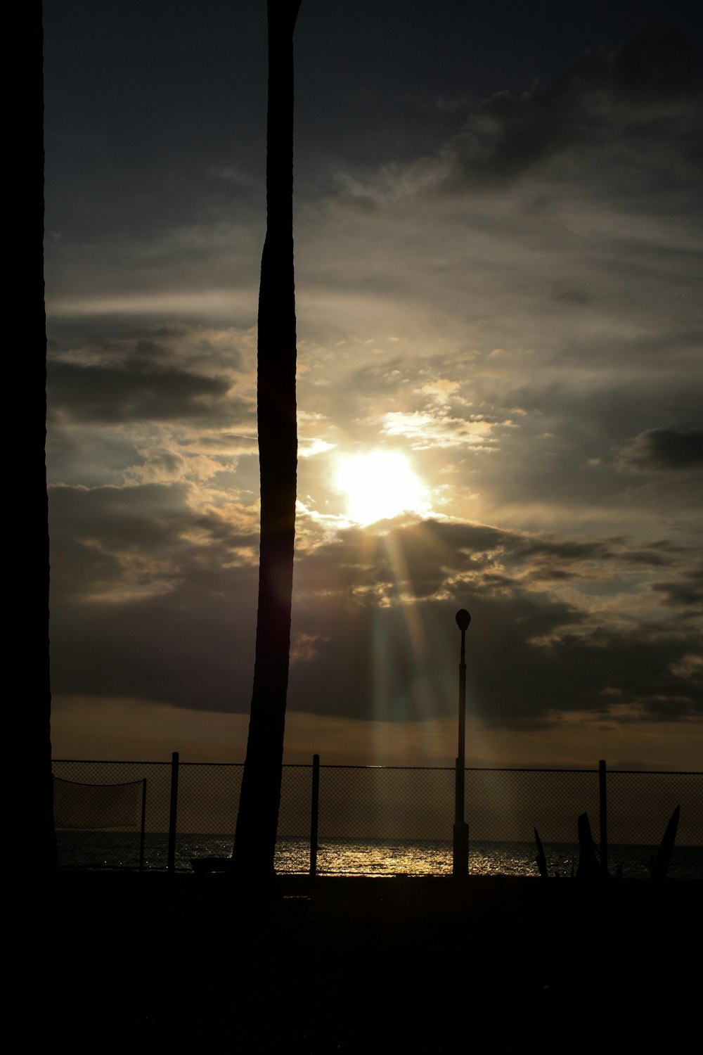 the sun is shining through the clouds over the ocean