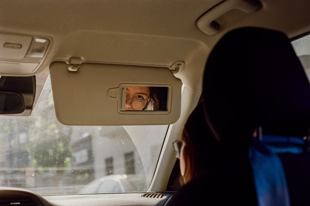 a woman in a car looking out the window