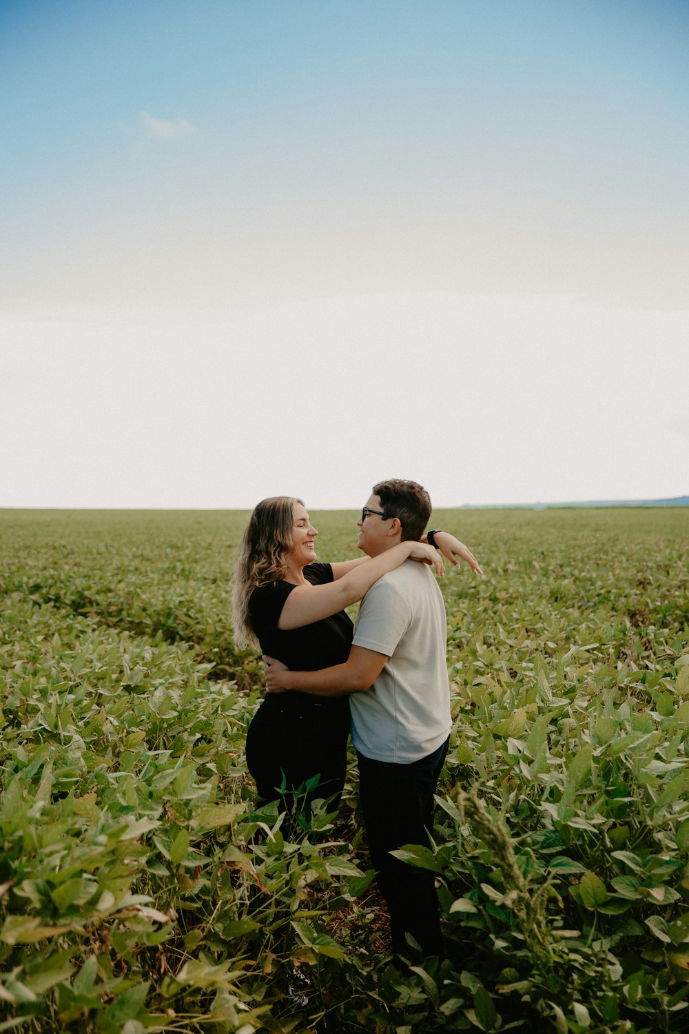 a man and a woman standing in a field
