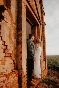 a man and a woman standing outside of a building