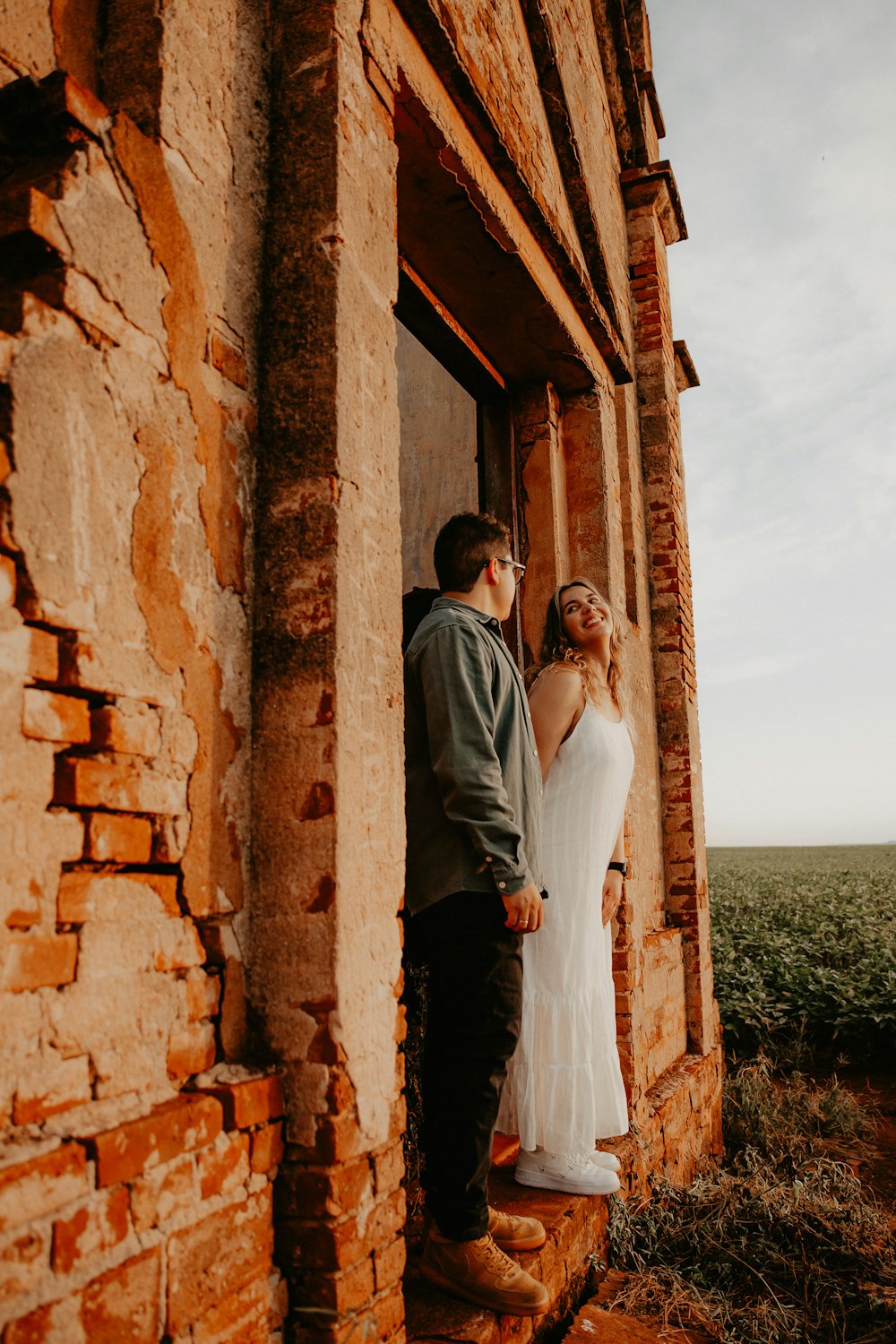 a man and a woman standing outside of a building