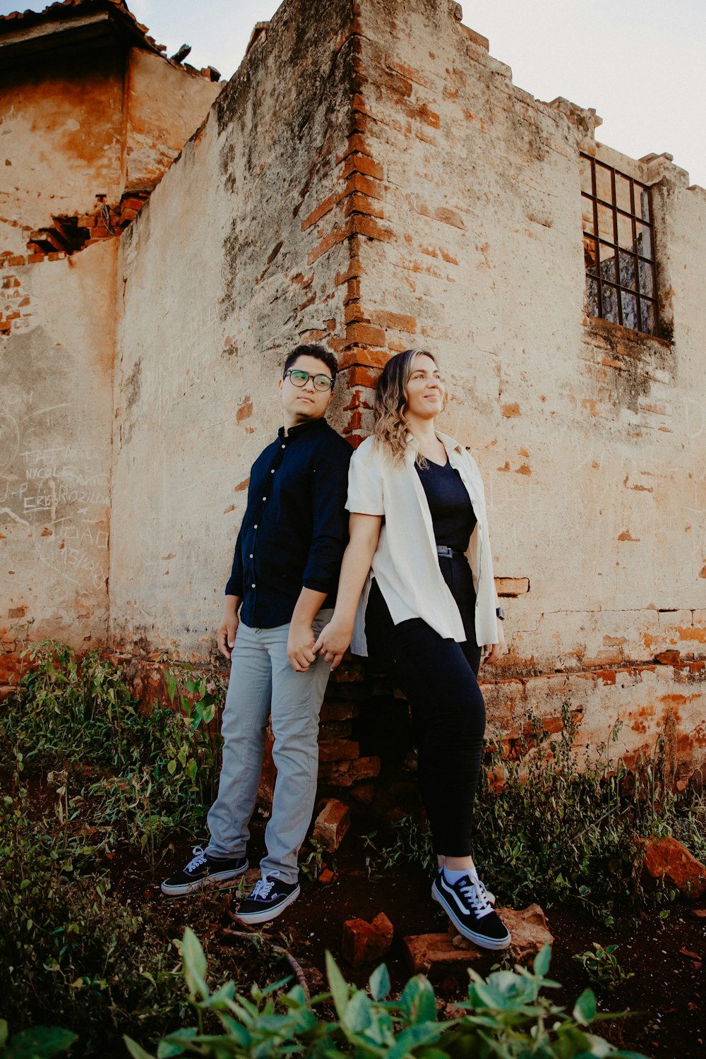 a man and a woman standing in front of a building