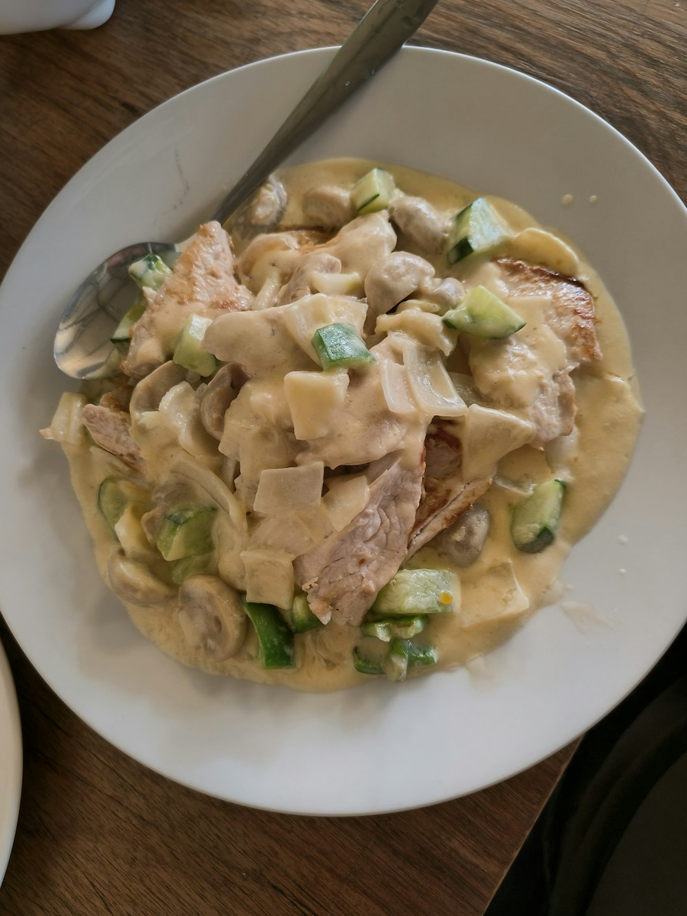 a white plate topped with pasta and meat