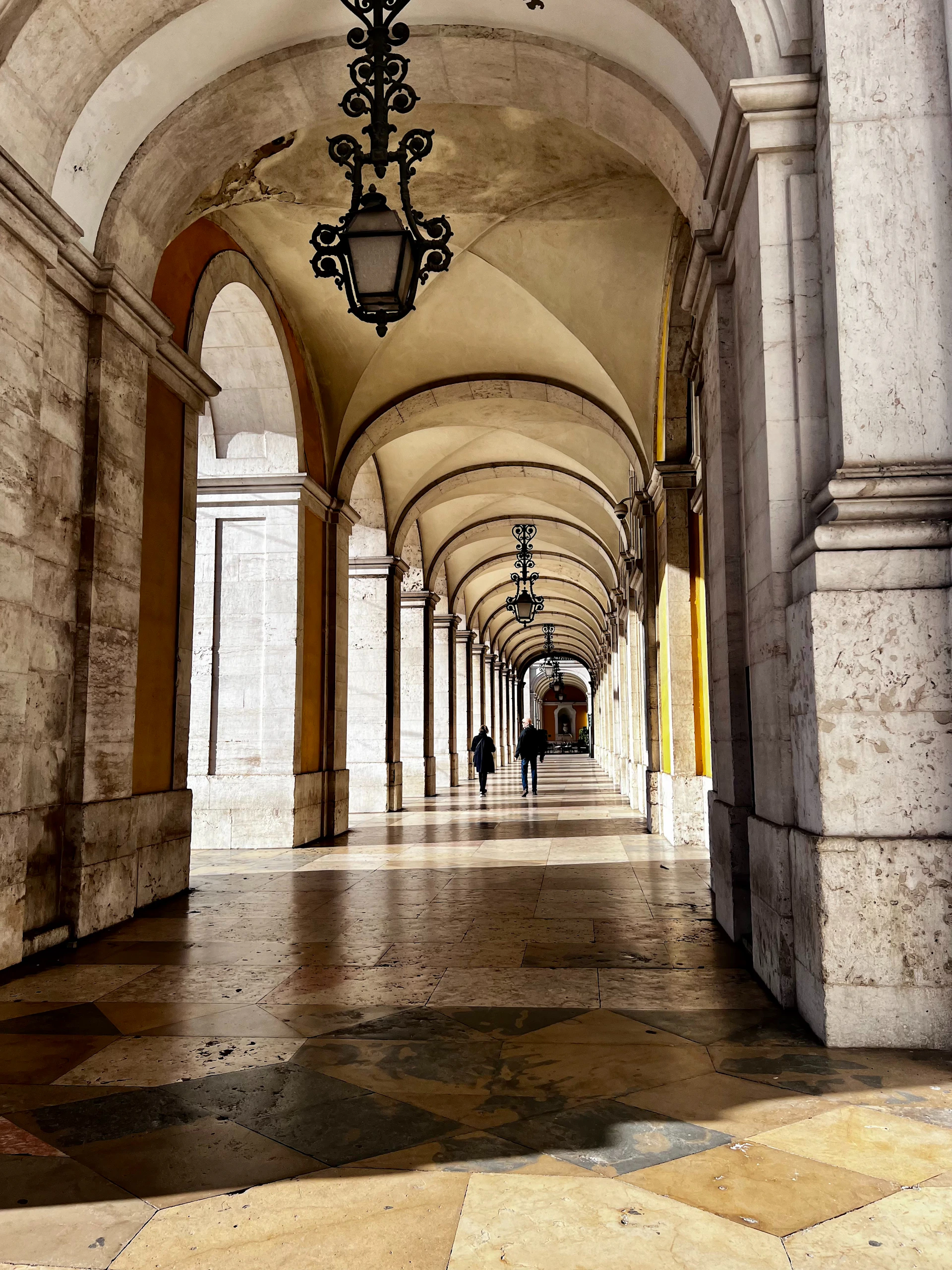 a long hallway with a clock hanging from the ceiling