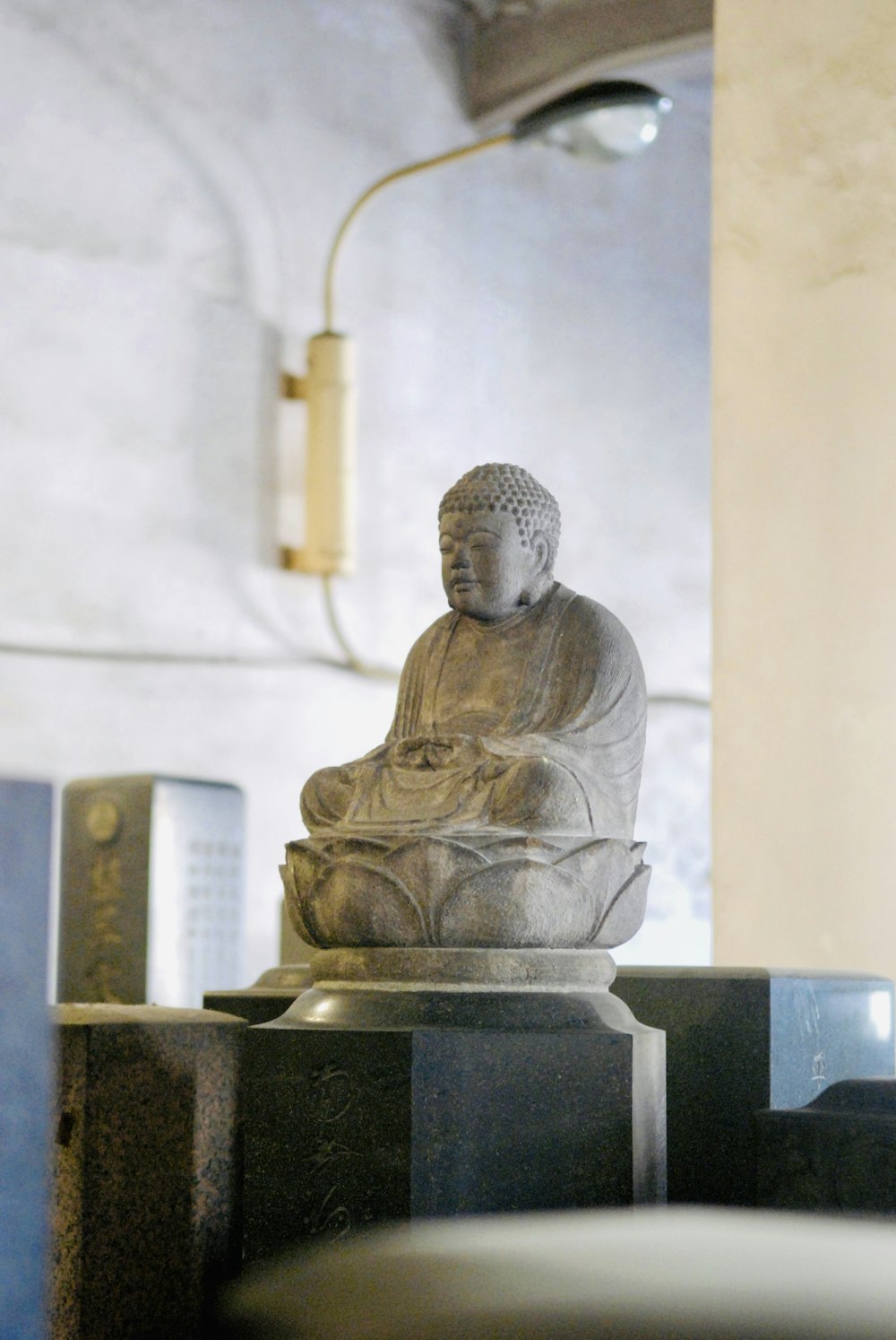 a buddha statue sitting on top of a table