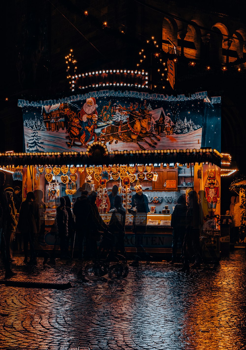 a group of people standing around a food stand