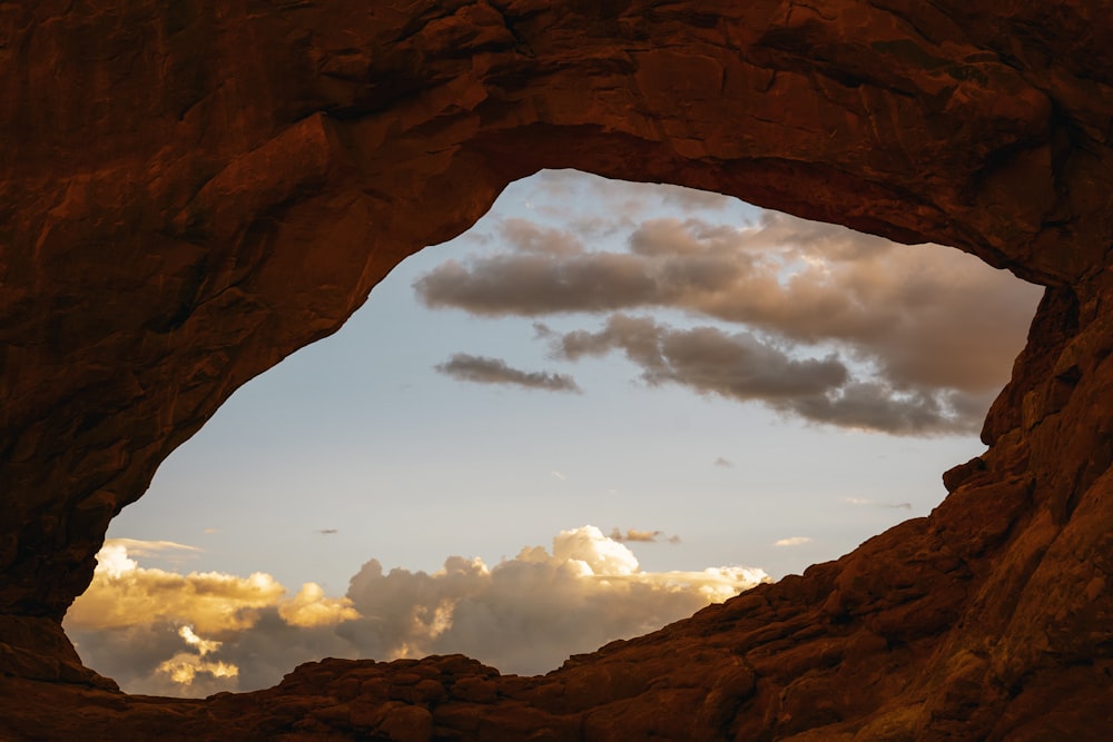 a large rock formation with a sky in the background