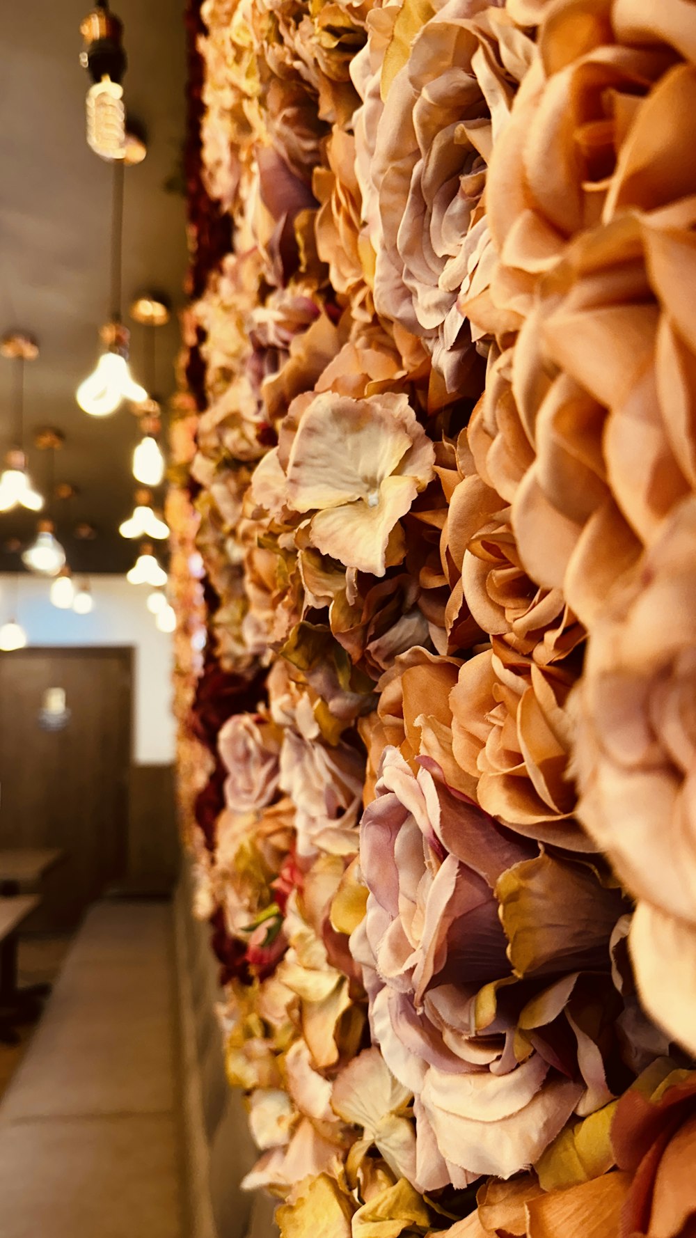 a wall of flowers in a restaurant