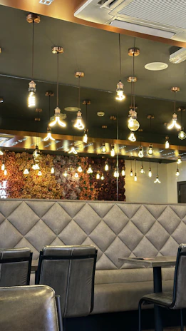 a restaurant with a bunch of lights hanging from the ceiling