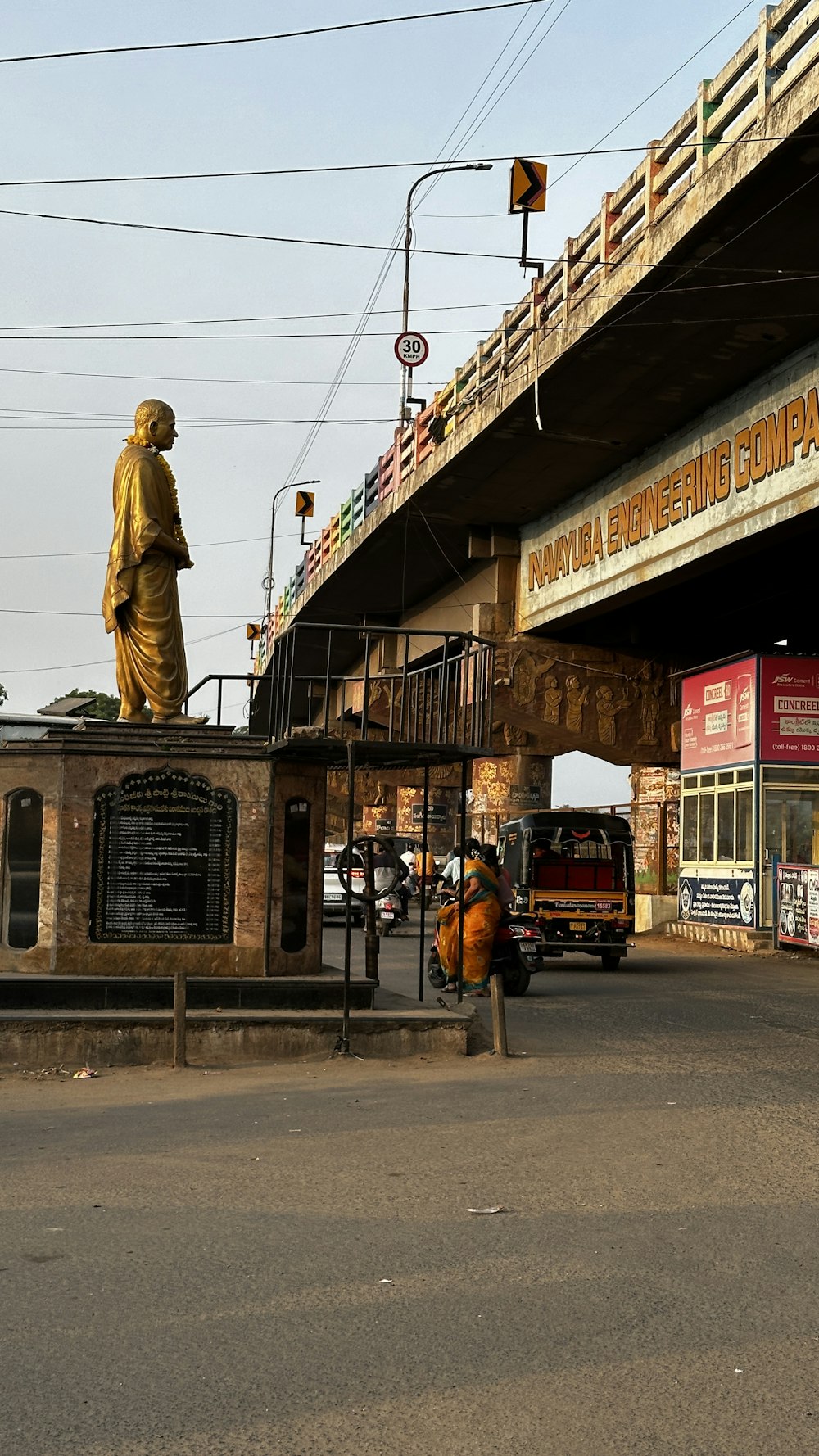 a statue of a man standing on top of a bridge
