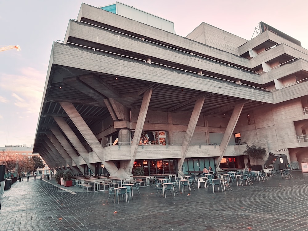 a large building with a bunch of tables in front of it