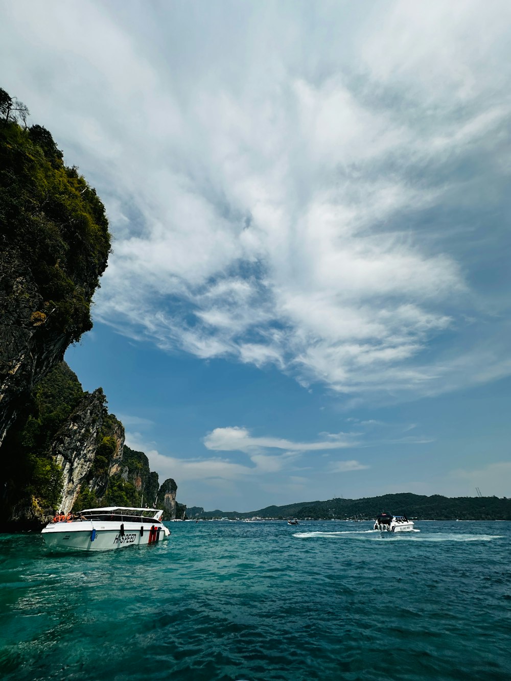 a couple of boats floating on top of a body of water