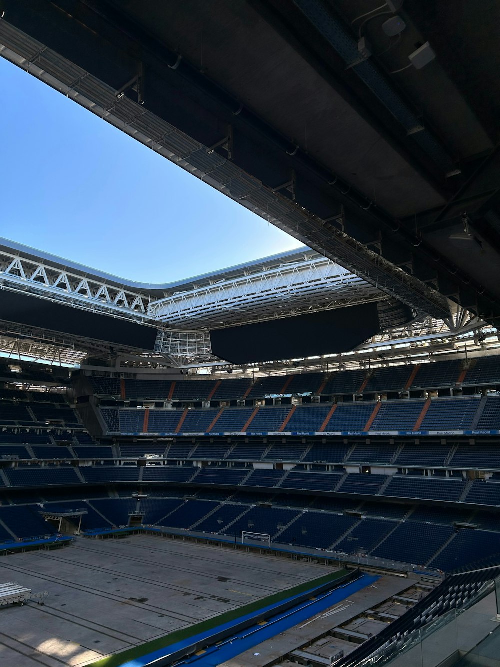 an empty stadium filled with lots of blue seats