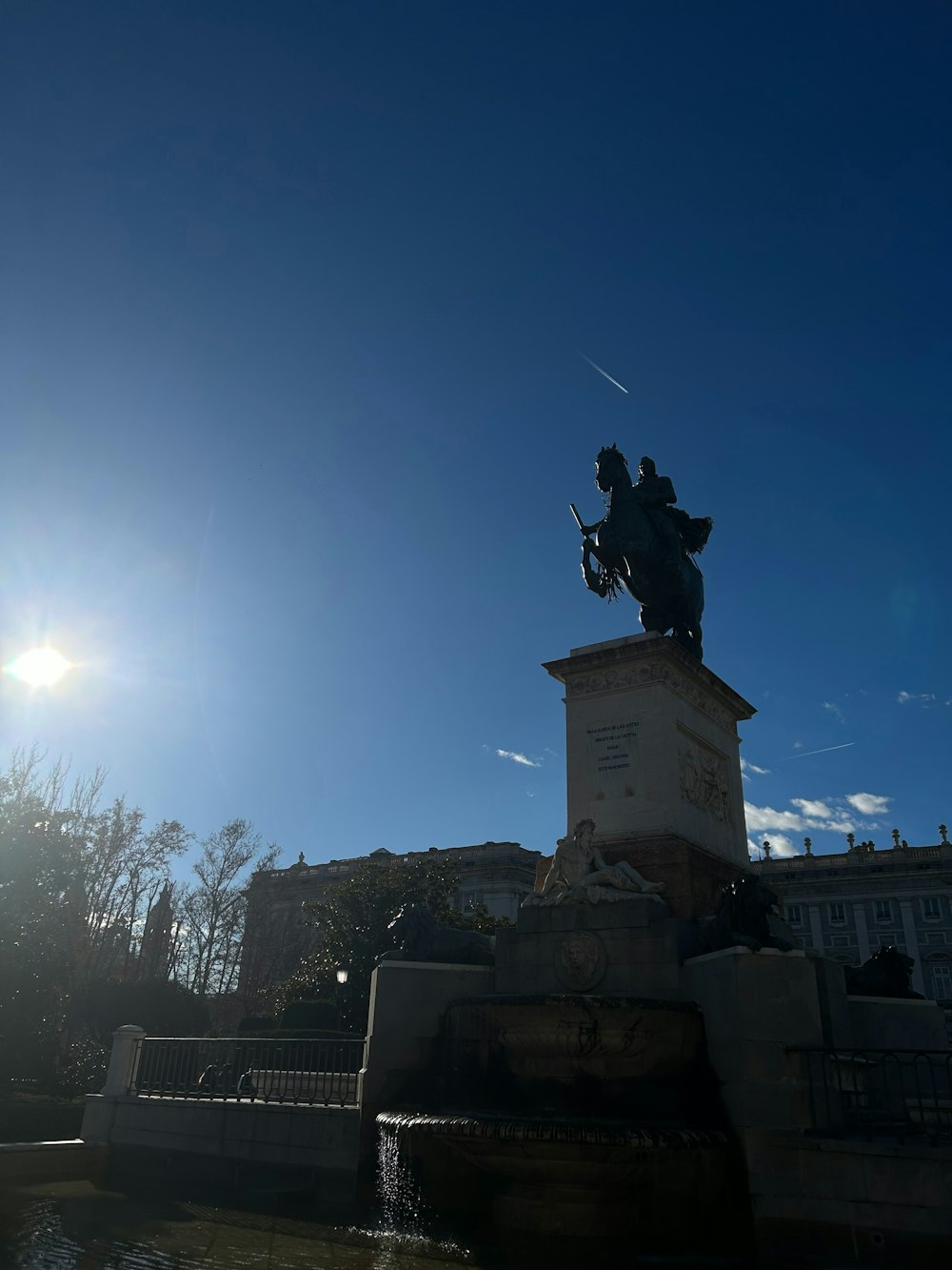 a statue of a man on a horse in front of a building