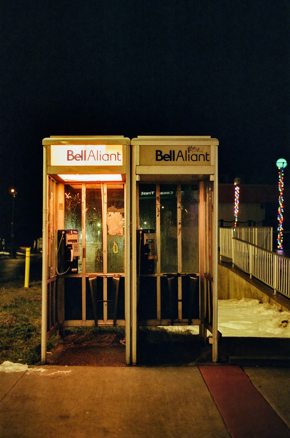 a phone booth sitting on the side of a road