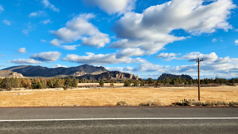 a view of a field with mountains in the background