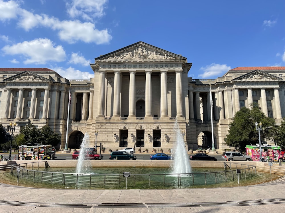 a large building with a fountain in front of it