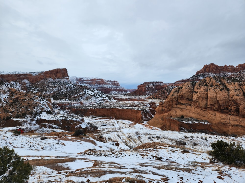 a snow covered landscape with mountains in the background