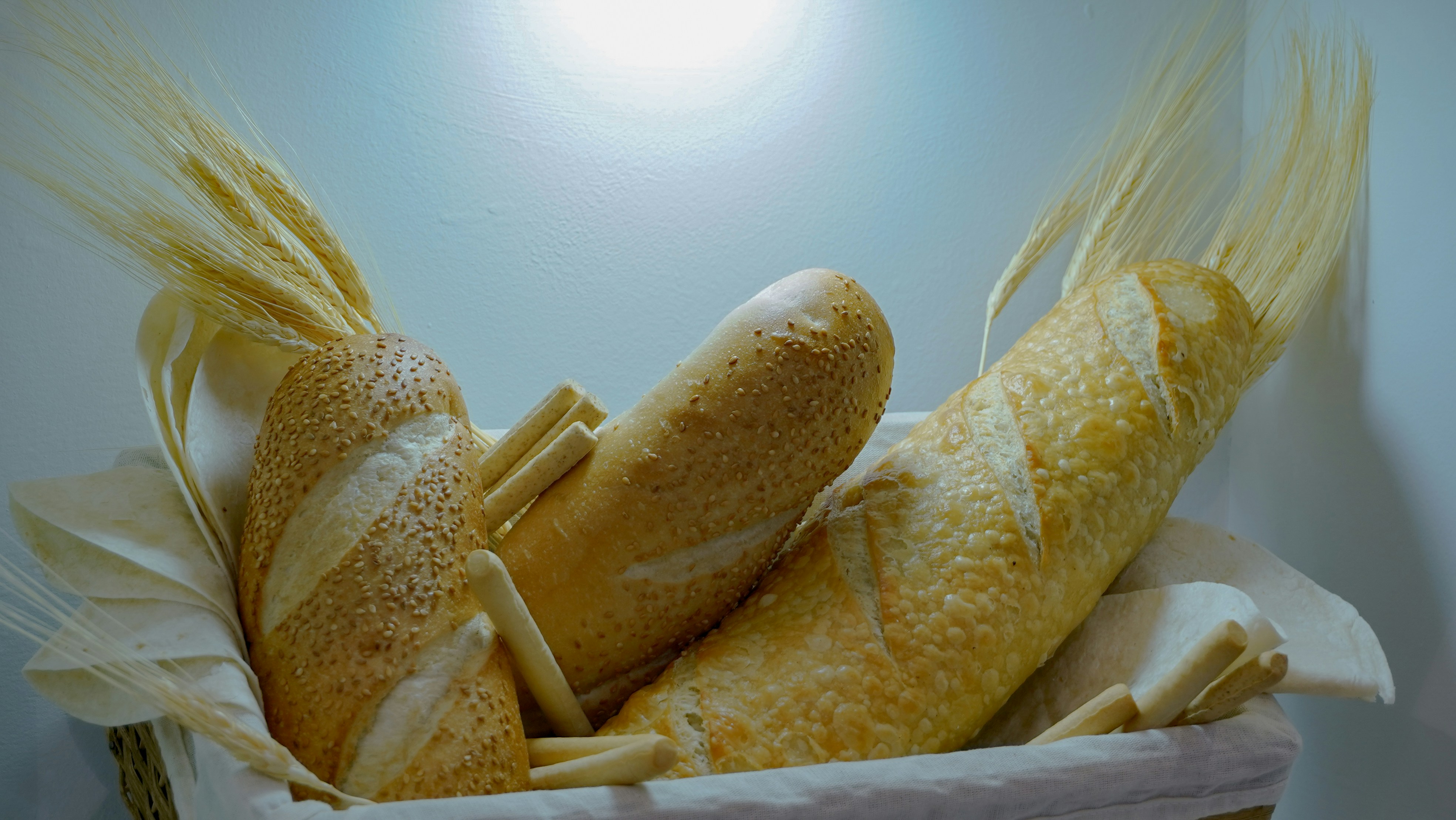 a basket of bread with ears of wheat