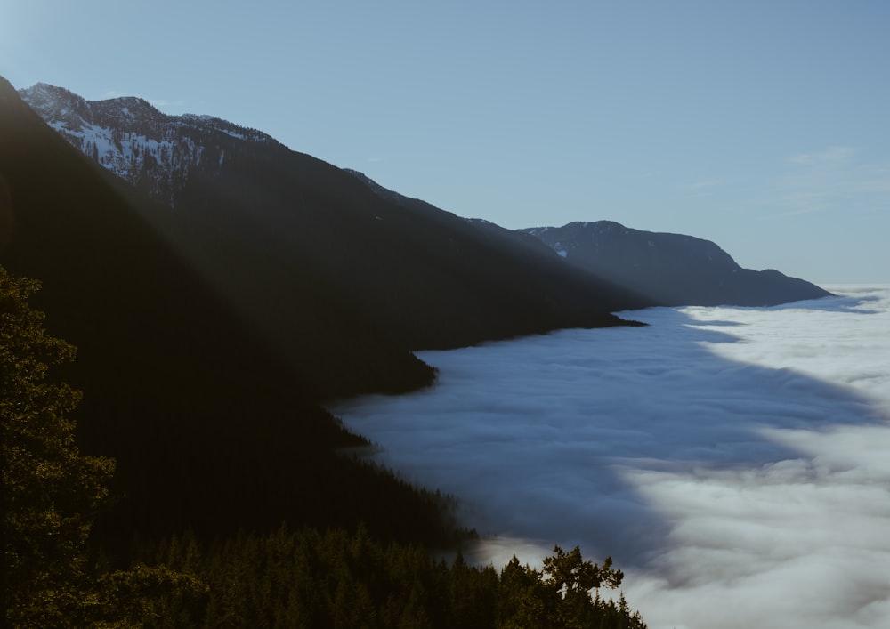 a view of a mountain with low lying clouds