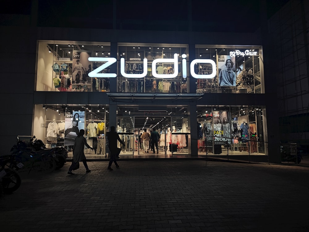 a group of people walking in front of a store