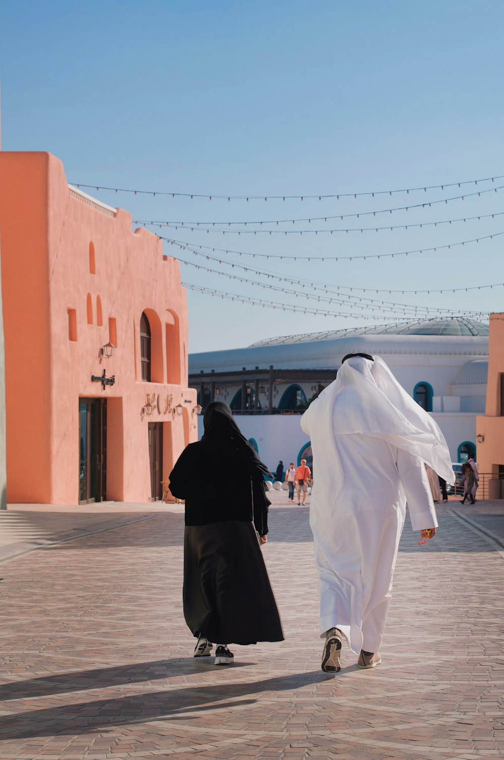 a couple of people that are walking down a street