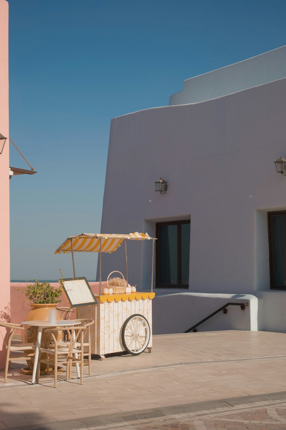 a food cart sitting on top of a patio next to a building