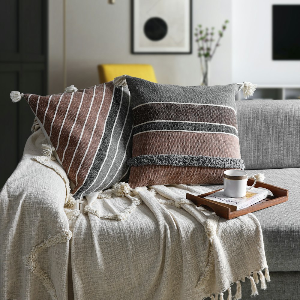 a coffee cup on a tray on a couch