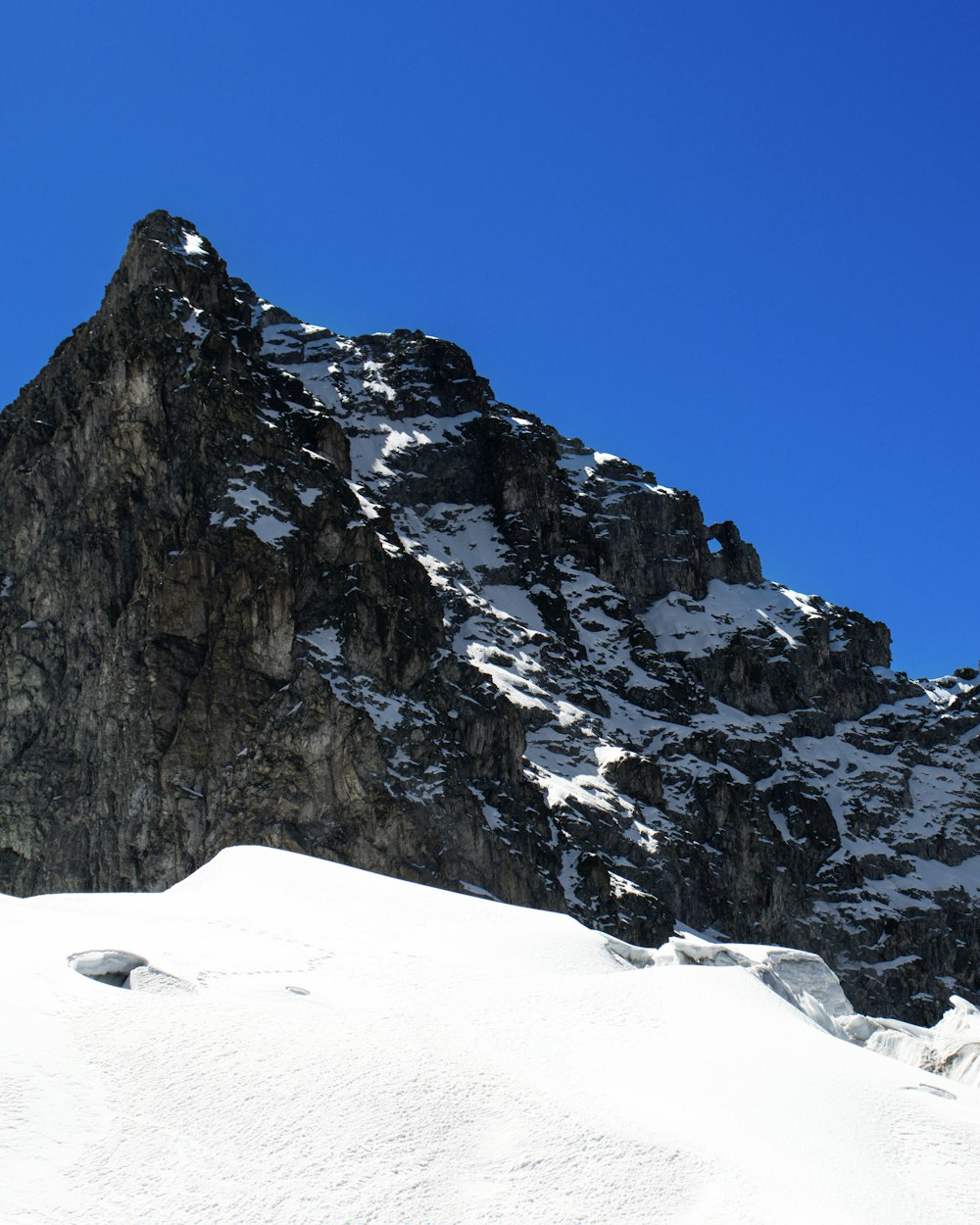 a man riding skis down a snow covered slope