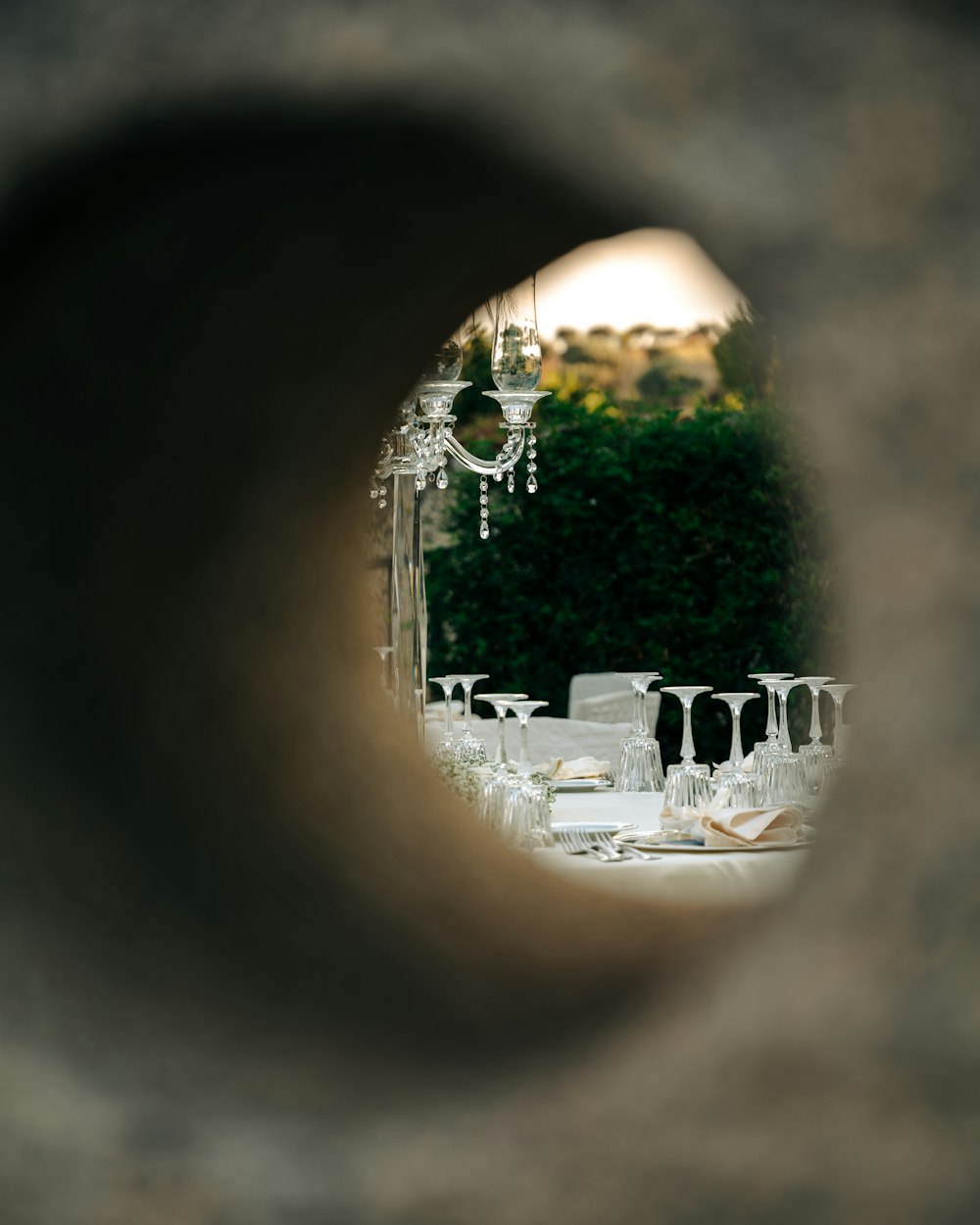 a view of a table through a hole in a wall