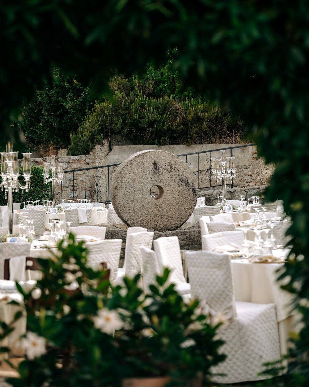 a large rock surrounded by tables and chairs
