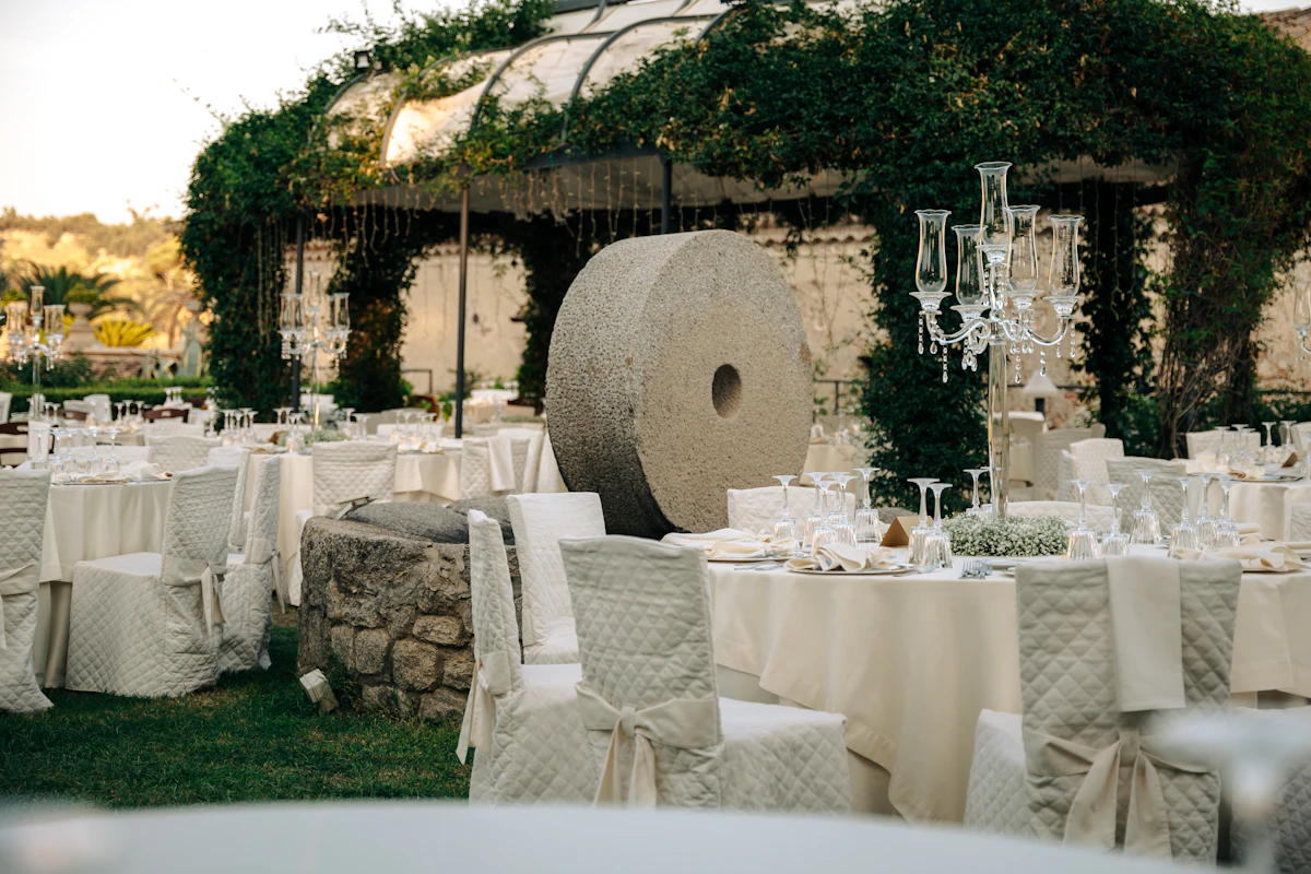Wedding reception tables with flowers and glass candle holders